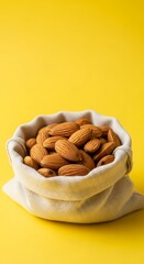 Raw Almonds in a Burlap Sack on Yellow Background Healthy Snack Food Concept