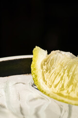Refreshing cocktail served in a glass with ice cubes and lime slices. Close-up of a cold drink with...