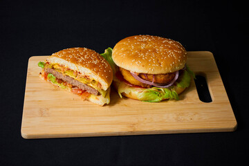 Juicy Hamburger with Lettuce and Onion on Board