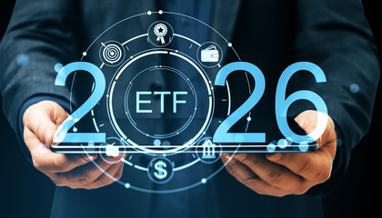 ETF investment concept for 2026 with digital interface symbols on transparent tablet held by person...