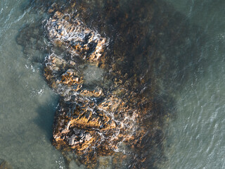 Aerial view of rocks in the ocean