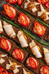 Traditional Ukrainian snack with black rye bread, sliced pork lard, mustard, and red pepper. Rustic appetizer served on a wooden board, close-up of authentic national cuisine. Popular dish for festive