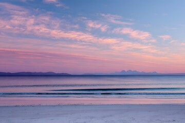 Pink sky over calm ocean and sandy beach sunset sunrise