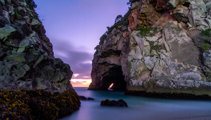 Coastal Rock Formation at Sunrise with Calm Ocean Water