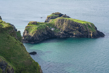 Tourists crossing Carrick a Rede rope bridge in Northern Ireland dramatic coastal scenery and thrilling cliffside adventure experience