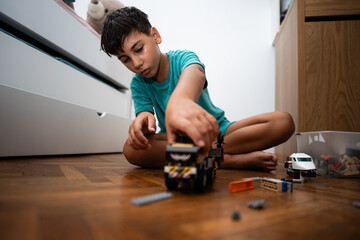 Child playing with construction toys in bedroom