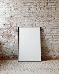 Blank framed poster on a brick wall