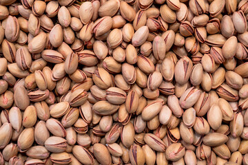 Close-Up Image of Pistachio Nuts in Their Shells for Background Use