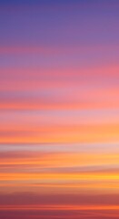Obraz premium Vibrant sunset sky with horizontal bands of purple, pink, orange, and yellow hues creating a colorful gradient.