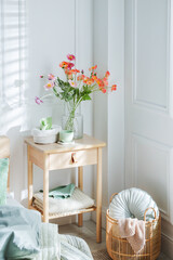 Bedside table with different decor near bed indoors