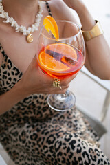 woman holding a glass of Aperol 