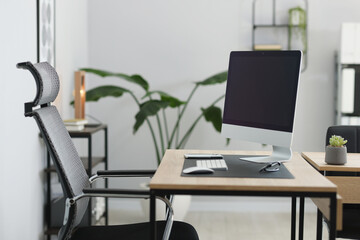 Stylish workplace with modern computer and on wooden table in office