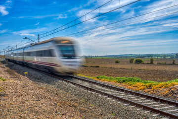 Naklejka premium Medium-distance train speeding through the countryside of Andalusia