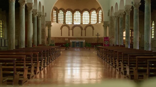 Handheld left-to-right shot from the church entrance toward the altar, with a lectern used as a blurred foreground frame.