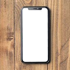 Modern smartphone on rustic wooden tabletop displaying blank screen.
