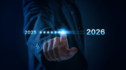 A businessman touches a digital progress bar indicating the transition from 2025 to 2026, symbolizing strategic planning, future readiness and challenge strategy for business startup