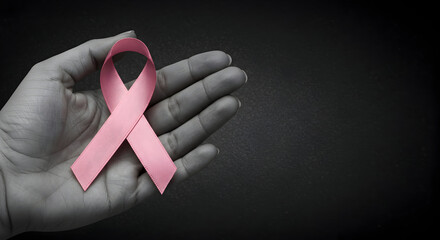 Embracing Hope And Strength For Breast Cancer Awareness With A Symbolic Pink Ribbon In A Human Hand Against A Dark Background