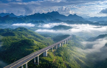 Obraz premium Highway crossing a mountain range shrouded in mist