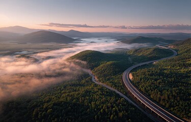 Highway winding through a valley at dawn