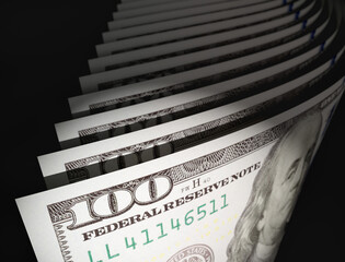 Spot Lit Abstract CLose-up Angle of U.S. 100 Dollar Bills Isolated on a Black Background.