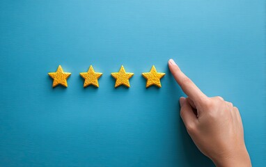 Hand pointing at four golden stars on a blue background