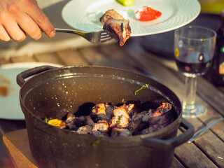 hand with fork sharing meat
