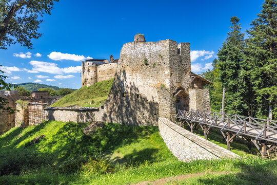 Zborov Castle near Bardejov town in North-Eastern Slovakia, Europe. Scenic view of a medieval stone castle on a hill under a blue sky, showcasing its historical architecture and scenic surroundings.