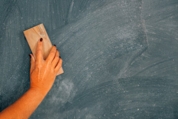 hand with eraser on the blackboard © carballo