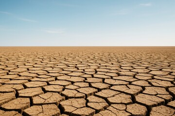 Fototapeta premium Cracked dry desert ground under clear blue sky showing extreme drought and climate change concept in natural environment background light scene. Ai generative