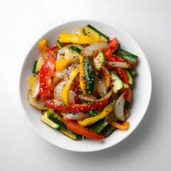 Colorful stir-fry with bell peppers, onions, and zucchini in a white bowl. Vibrant vegetarian meal perfect for healthy lifestyle visuals.