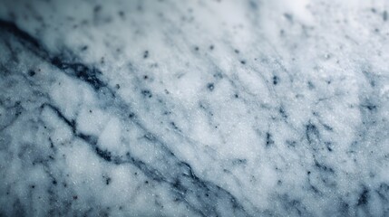 Close-up view of a marble surface showcasing intricate veining patterns in shades of gray and blue.