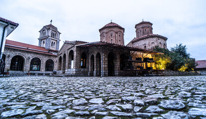 Saint Naum Monastery - Macedonia ancient orthodox monastery with three domes and a stone courtyard at dusk. © Blackbookphoto