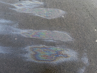 Stains of gasoline on asphalt