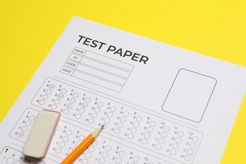 Answer sheet, pencil and eraser on yellow background, closeup. Student passing exam