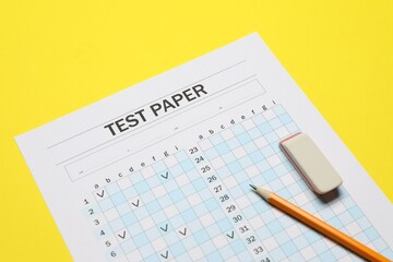 Answer sheet, pencil and eraser on yellow background, closeup. Student passing exam