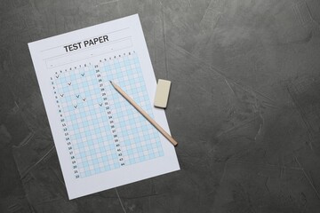 Student passing exam. Answer sheet, pencil and eraser on gray textured table, flat lay. Space for...