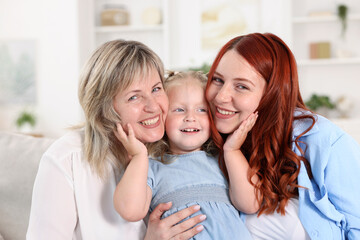 Grandmother, her daughter and granddaughter at home