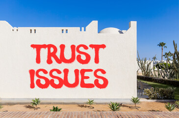 Trust issues symbol. Concept word Trust issues on beautiful white wall. Beautiful blue sky...