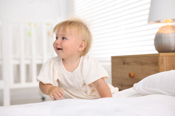 Fototapeta premium Cute little baby on bed in room