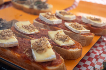 Spanish tapas with cheese, tomato spread and crispy onions.