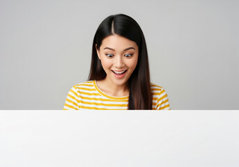 Excited woman holding a blank white board with copy space


