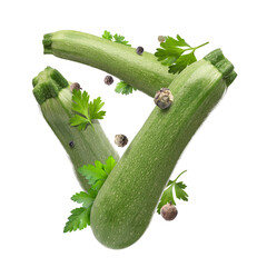Fresh zucchinis, parsley and peppercorns falling on white background