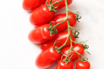 Fresh cherry tomatoes on vine. Red ripe vegetables on white background. Healthy organic produce....