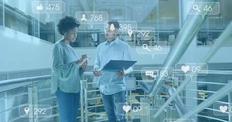 Colleagues gesturing at smartphone and monitoring floating engagement metrics on laptop in atrium - Powered by Adobe