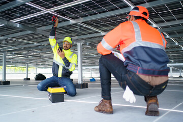 Engineers installing solar panels on rooftop.