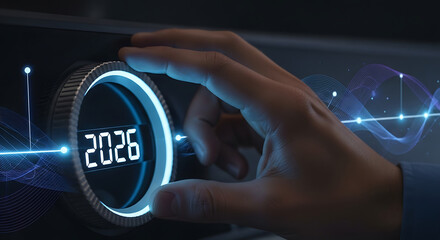 Concept of future technology and new year 2026. A hand adjusting a modern control dial with a glowing digital interface and abstract data waves