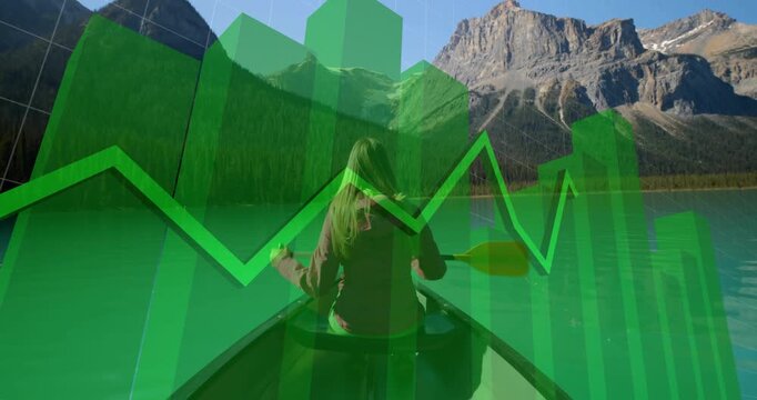 Mid adult woman dipping paddle into lake, generating bar and line overlays enhancing tech analytics