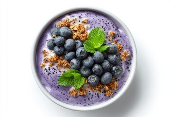 Yogurt parfait topped with blueberries, granola, and mint