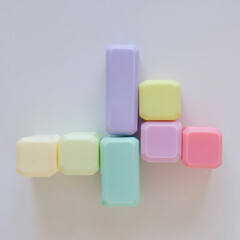 Obraz premium A pastel colored arrangement of square and rectangular blocks on a white surface creating a cross shape