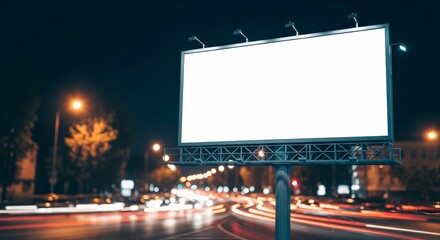 Blank Billboard at Night with Streaking Car Lights on City Street.